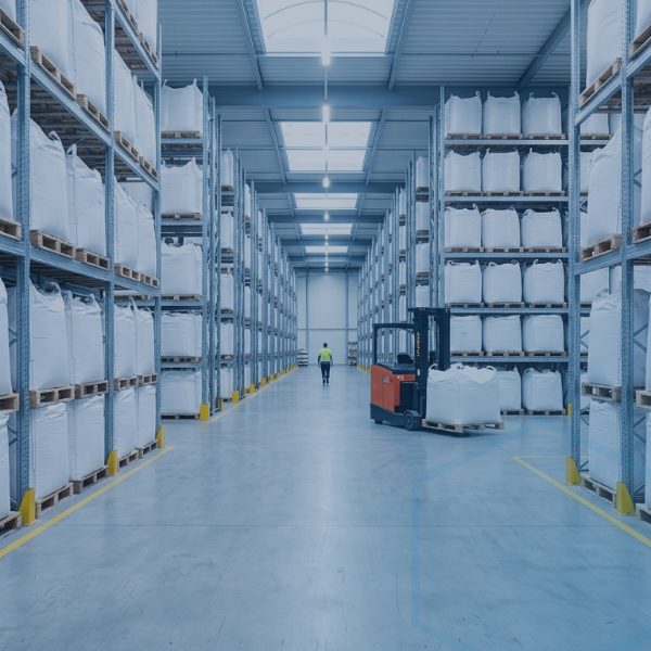 Rows of FIBC bulk bags stacked on warehouse racking, illustrating bagged phosphate raw material inventory